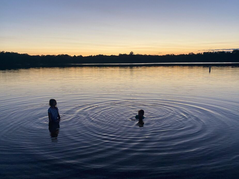 Kids in lake - sunset behind